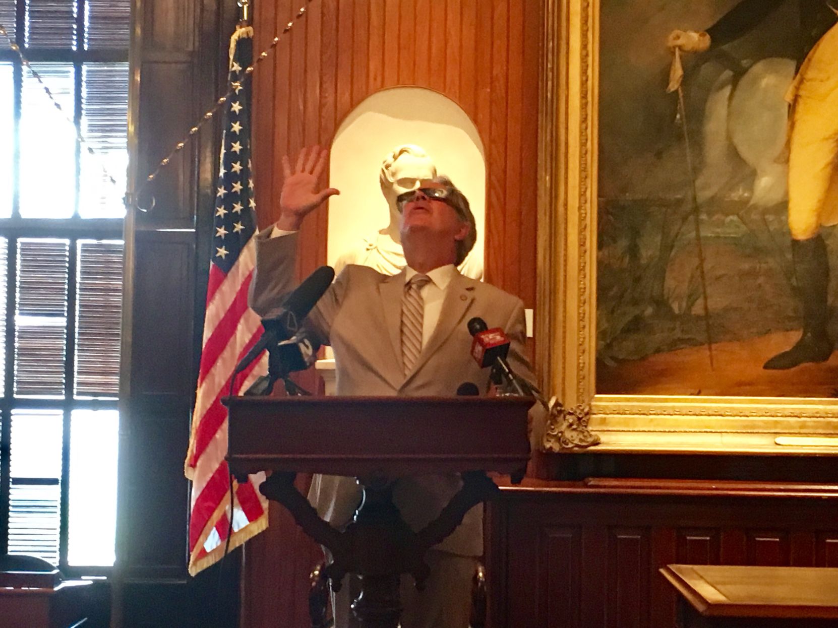 Charleston Mayor John Tecklenburg shows off his eclipse glasses